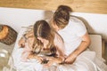 Couple of guy and girl lying in bed watching the cell phone Royalty Free Stock Photo