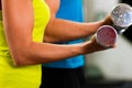 Couple in gym exercising with dumbbells Royalty Free Stock Photo