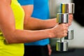 Couple in gym exercising with dumbbells Royalty Free Stock Photo