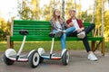 Couple with gyroboard sitting on the bench in park