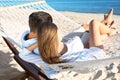 Couple relaxing in hammock on beach. Summer vacation