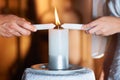 Couple, hands and candle at wedding for unity, love and commitment at church or ceremony with closeup. Marriage, man and Royalty Free Stock Photo