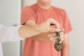 couple hands holding key of new house