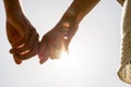 Couple Hands Holding Together with Sun Rays Royalty Free Stock Photo
