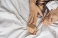 Couple hands pulling white sheets in ecstasy, orgasm. Concept of passion. Oorgasm. Erotic moments. Intimate concept. Sex Royalty Free Stock Photo