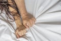 Couple hands pulling white sheets in ecstasy, orgasm. Concept of passion. Oorgasm. Erotic moments. Intimate concept. Sex