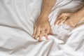 Couple hands pulling white sheets in ecstasy, orgasm. Concept of passion. Oorgasm. Erotic moments. Intimate concept. Sex