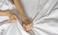 Couple hands pulling white sheets in ecstasy, orgasm. Concept of passion. Oorgasm. Erotic moments. Intimate concept. Sex Royalty Free Stock Photo