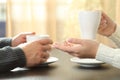 Couple hands talking holding coffee cups on a table at home Royalty Free Stock Photo