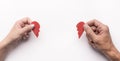 Couple hands with two halves of broken red paper heart Royalty Free Stock Photo