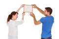 Couple hanging picture on wall Royalty Free Stock Photo