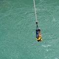 Couple hanging on a rope after a bungy jump at Kawarau Bridge