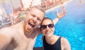 Couple happy caucasian beautiful young woman and man make selfie photo on background swimming pool. Concept travel Royalty Free Stock Photo