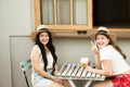 Couple of happy and cheerful curvy girls enjoy friendship together sitting on a cafe -young girls in outdoor leisure activity have