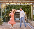 Couple, happy dancing together and outdoor love to celebrate relationship, cute dance spin and relationship activity Royalty Free Stock Photo