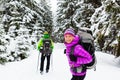 Couple happy hikers trekking in winter woods