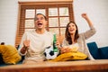 Couple of happy husband and wife watching sports match together Royalty Free Stock Photo