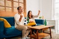 Couple of happy husband and wife watching sports match together Royalty Free Stock Photo