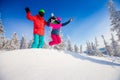 Couple happy lover having jump fun in winter snow forest. Snowbarders and skiers team friendship