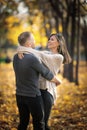Couple of happy lovers dancing in autumn park on a date Royalty Free Stock Photo