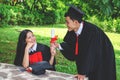 Couple happy smiling graduates, Woman students friends in graduation gowns holding diplomas and congratulate each other Royalty Free Stock Photo