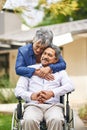 Couple, happy woman and senior man with wheelchair in backyard for care, love or bonding. Retirement, female pensioner Royalty Free Stock Photo