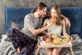 Couple has breakfast in bed Royalty Free Stock Photo