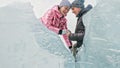 Couple has fun during winter walk against background of ice of f