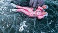 Couple has fun during winter walk against background of ice of f