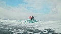 Couple has fun during winter walk against background of ice of f