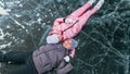 Couple has fun during winter walk against background of ice of f