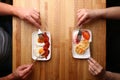 Couple have breakfast on wood table cheese pancake with sour cream and fried egg with bacon top view Royalty Free Stock Photo