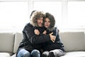 Couple have cold on the sofa at home with winter coat Royalty Free Stock Photo