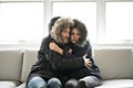 Couple have cold on the sofa at home with winter coat Royalty Free Stock Photo