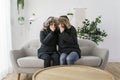 Couple have cold on the sofa at home with winter coat Royalty Free Stock Photo