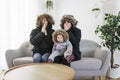 Couple have cold on the sofa at home with winter coat with baby Royalty Free Stock Photo