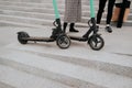 Couple have a good time together riding electric scooters around city. Eco-friendly transport concept. Modern Royalty Free Stock Photo