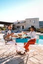 Couple having breakfast in garden looking out over the hills of Sicily, men and woman of mid age on vacation having Royalty Free Stock Photo