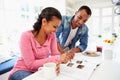 Couple Having Breakfast And Reading Magazine In Kitchen Royalty Free Stock Photo