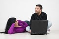 Couple having a conversation and using laptop Royalty Free Stock Photo
