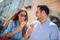 Couple having date and eating ice cream after shopping Royalty Free Stock Photo
