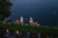 Romantic scenery of the couple having dinner under lanterns and enjoying magnificent view of Lake Como in Varenna, Italy. Royalty Free Stock Photo