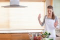 White home cook lifting and preparing vegetables in colander by pot in kitchen, copy space Royalty Free Stock Photo