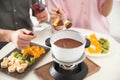 Couple having fondue dinner at table