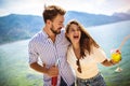 Couple having fun on the beach, drinking cocktails and smiling Royalty Free Stock Photo