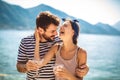 Couple having fun on the beach, drinking cocktails and smiling Royalty Free Stock Photo