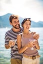 Couple having fun on the beach, drinking cocktails and smiling Royalty Free Stock Photo
