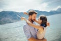 Couple having fun on the beach, drinking cocktails and smiling Royalty Free Stock Photo