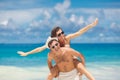 Couple having fun on the beach of a tropical ocean. Royalty Free Stock Photo