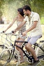 Couple having fun by bike on holiday to the lake